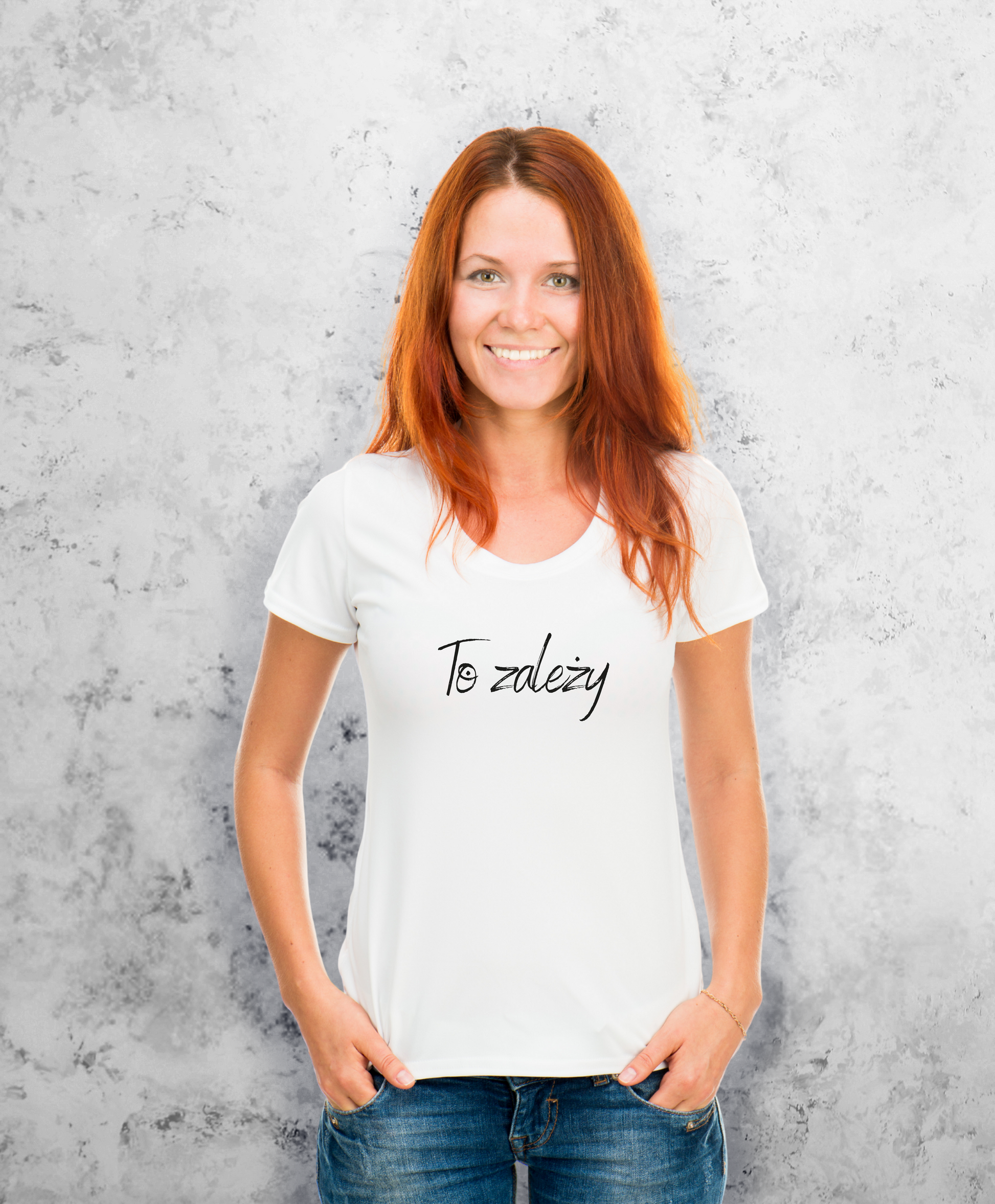 Zdjęcie przedstawia uśmiechniętą kobietę, ubraną w białą koszulkę z czarnym napisem na przodzie "To zależy"